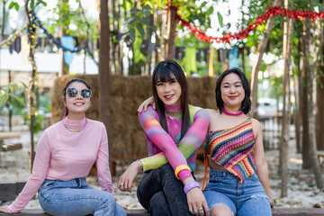 Fototapeta na wymiar Happy friends LGBTQ transgender Asian woman LGBTQIA holding each other in summer party. friendship concept