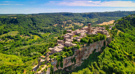 Panoramic aerial view of Civita di Bagnoregio from a flying drone around the medieval city, Italy.