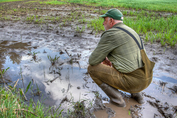 As the farmer surveys his flooded field, he feels a sense of despair. Climate change has brought...