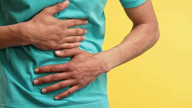 Man squeezing belly hands because of abdominal pain. Suffering stomach ache.