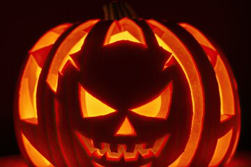 Halloween pumpkins under the moonlight, carved jack o lantern in the dark, generative ai