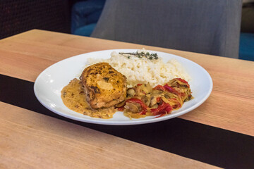 Chicken steak with rice and steamed vegetables.