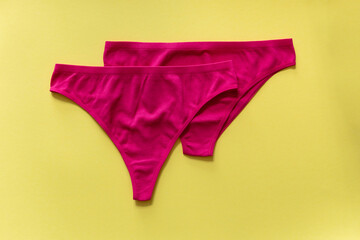 Set of colorful underpants on yellow background, close up