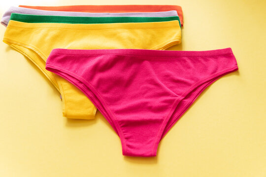 Set of colorful underpants on yellow background, close up