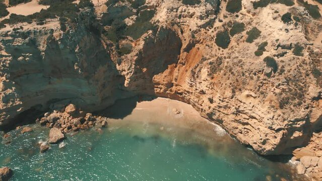 A picturesque sandy beach cove and clear blue water in the Algarve, portugal