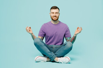 Full body young man wear purple t-shirt hold spreading hands in yoga om aum gesture relax meditate...