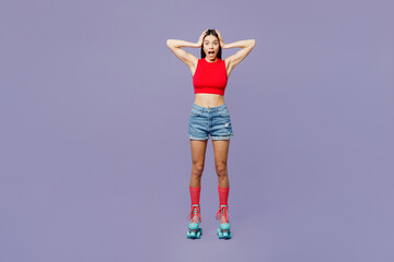 Full body surprised young latin woman she wear red casual clothes rollers rollerblading put hands on head look camera isolated on plain pastel purple background Summer sport lifestyle leisure concept