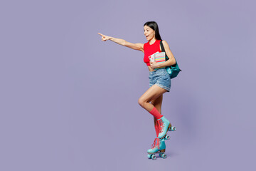 Fototapeta na wymiar Full body young latin woman wear red casual clothes rollers backpack rollerblading point index finger aside on area hold books isolated on plain pastel purple background. Summer sport leisure concept.