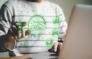 Entrepreneur hand point at digital screen dashboard while control and reduce carbon emission for global friendly business. Business with environment concern, carbon credit and zero emission.