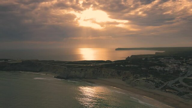 Aerial view of sunset clouds over the ocean in Sagres, Portugal