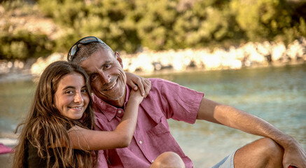 Happy family resting at beach in summer. Father and daughter together on the beach chair smiling