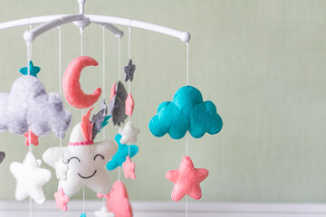 Toys above the baby crib. Baby crib mobile with stars, clouds and moon