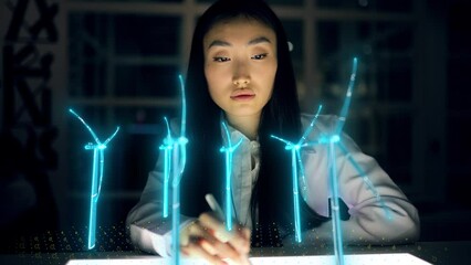 Futuristic Female Engineer Designs in 3D Field with Wind Turbines. Asian Woman Use Augmented Reality Hologram to Work on Green Energy Environmental Power Production - Powered by Adobe