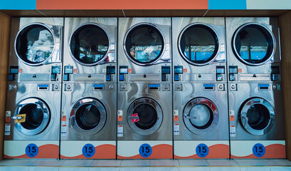 Rows of industrial laundry machines in the large laundromat.
