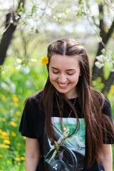 Beautiful young woman in flowers.Blossoming tree.Happy woman.Emotion of pleasure and happiness.Spring portrait.Brunette with long hair.Hair care.Nature portrait.Blossoming tree.The girl laughs.
Spring