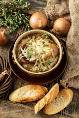 Cheesy vegetarian French onion soup  in ceramic bowl