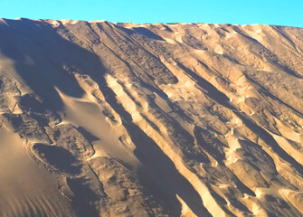 Fototapeta premium Untouched natural sand dunes with blue sky good for nature background