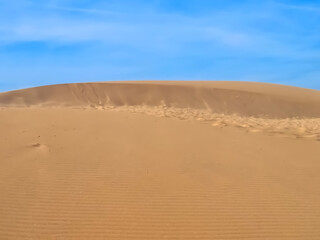 Untouched natural sand dunes with blue sky good for nature background