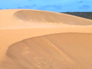 Untouched natural sand dunes with blue sky good for nature background