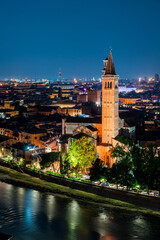 Obraz premium Famous old town of Verona at night. Colorful city lights reflecting in the river Adige. Long exposure.
