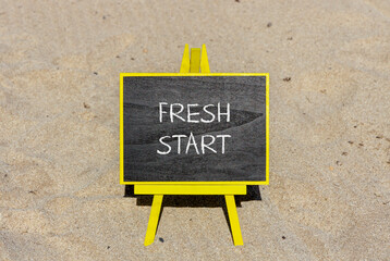 Fresh start and motivational symbol. Concept words Fresh start on beautiful black chalk blackboard on a beautiful sand beach background. Business motivational and Fresh start concept. Copy space.