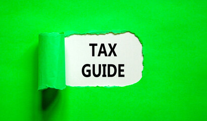 Tax guide symbol. Concept words Tax guide on beautiful white paper. Beautiful green table green background. Business and Tax guide concept. Copy space.