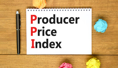 PPI Producer price index symbol. Concept words PPI Producer price index on white note. Beautiful wooden table wooden background. Business and PPI Producer price index concept. Copy space.