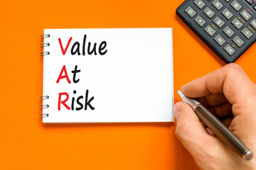 VAR Value at risk symbol. Concept words VAR Value at risk on beautiful white note. Businessman...