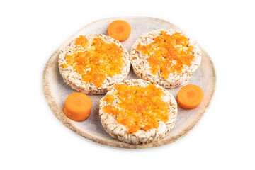 Carrot jam with puffed rice cakes isolated on white. Side view.