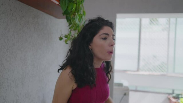 Intense domestic argument between couple. Woman expresses anger and frustration while discussing relationship problems with her partner at home