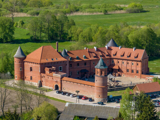 Tykocin castle on sunny day surrounded with green meadows and trees - drone aerial photography...