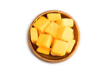 Dried mango cubes in wooden bowls isolated on white, top view