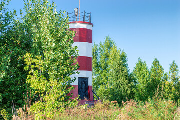 White-Red Lighthouse Surrounded by Deciduous Trees