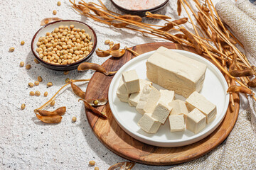Fresh Tofu cheese with soybeans. Cube pieces, healthy ingredient for vegan lifestyle, modern stand