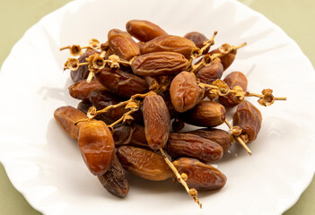 Dates or dattes palm fruit in white bowl is snack healthy, Set of various dates in plate, Different kind of raw date fruit ready to eat, concrete background, Traditional, delicious and healthy ramadan