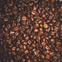 Top view background of aromatic brown coffee beans scattered on surface, 
roasted coffee beans,  background coffee beans