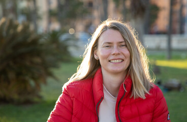happy beautiful woman enjoying sunset in the park