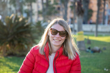 happy beautiful woman enjoying sunset in the park
