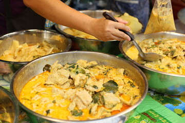 selling thai Green curry with meatballs, eggplant , coconut shoots and bamboo shoots in the market