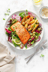 Salmon fillet grilled, fried potato and fresh vegetable green salad, top view - 600227508