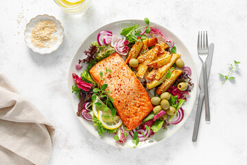 Salmon fillet grilled, fried potato and fresh vegetable green salad, top view - 600227518