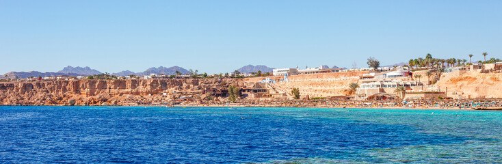 Fototapeta na wymiar Sunny resort beach on the Red Sea in Sharm el Sheikh, Sinai, Egypt