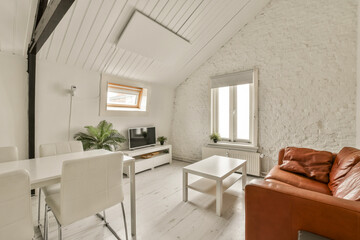 a living room with a couch, table and television set in the center of the room is whitewashed wood flooring