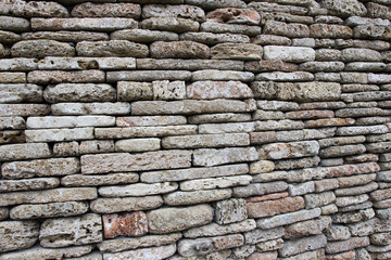 The wall is made of natural stone