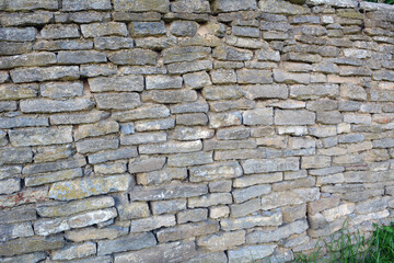 The wall is made of natural stone