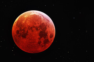 Red moon, on a black background. Elements of this image furnished NASA.