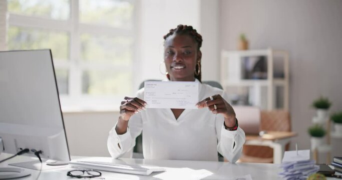 Holding Paycheck Or Payroll Check Or Insurance Cheque