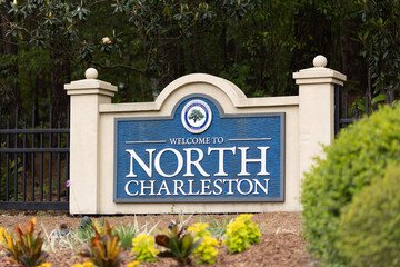 North Charleston, South Carolina city limits welcome sign with trees and flowers off of interstate...