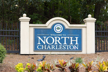 North Charleston, South Carolina city limits welcome sign with trees and flowers off of interstate...