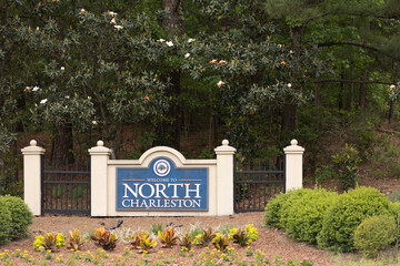 North Charleston, South Carolina city limits welcome sign with trees and flowers off of interstate...